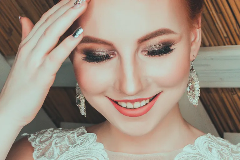 Smiling bride with full eyelash extensions and glam makeup at Dockside Salon in Muskegon, MI