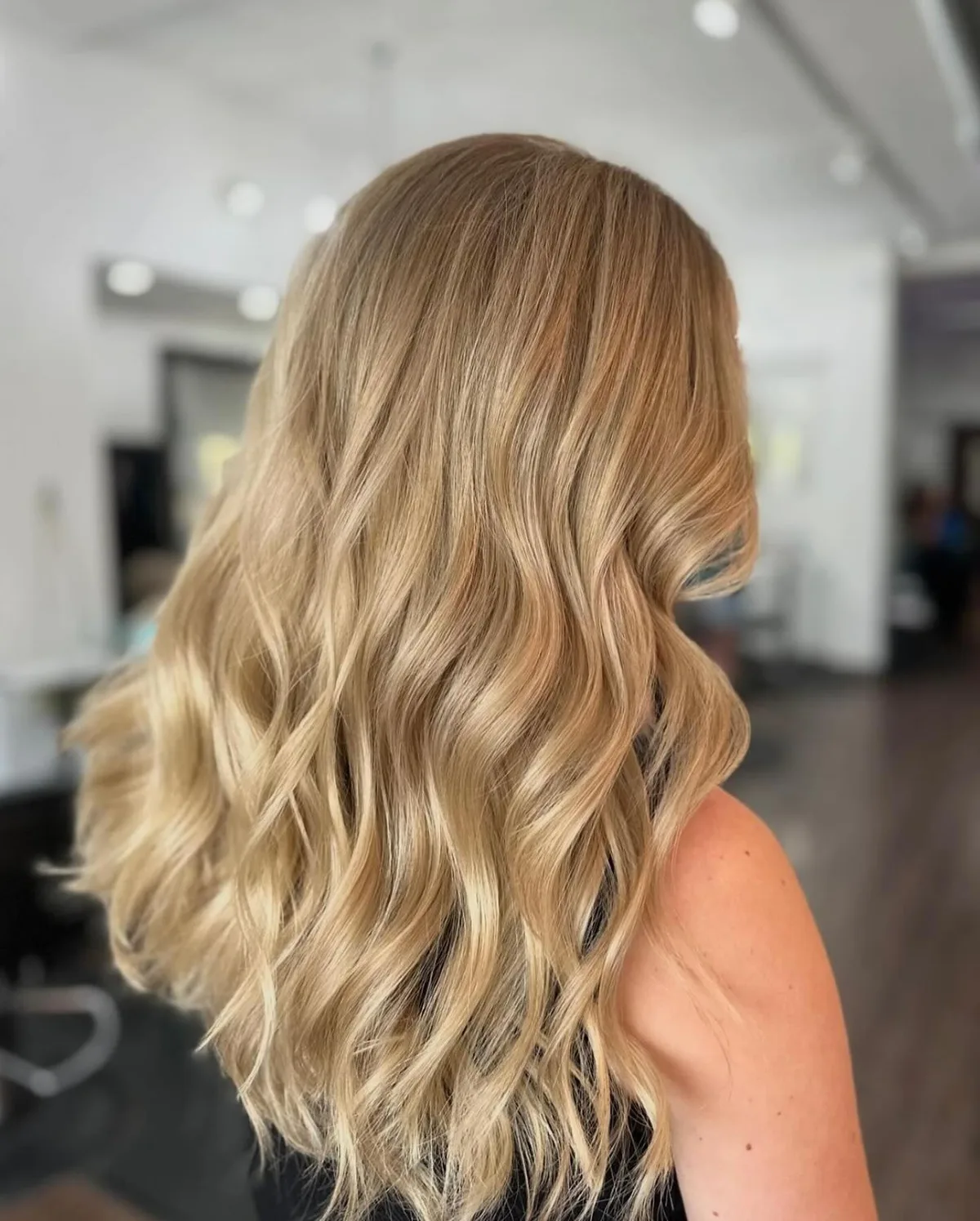 Soft blonde waves with healthy shine after a treatment at Dockside Salon in Muskegon, MI