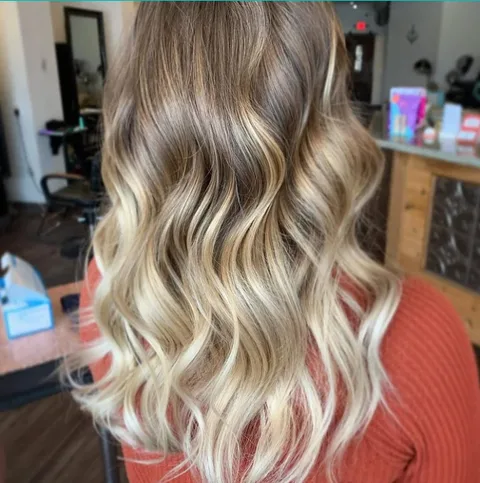 Bright blonde balayage with polished waves at Dockside Salon, Muskegon