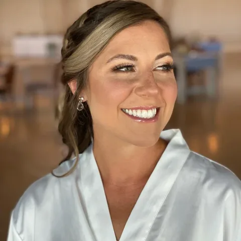 Bridal updo with side braid and natural makeup at Dockside Salon, Muskegon