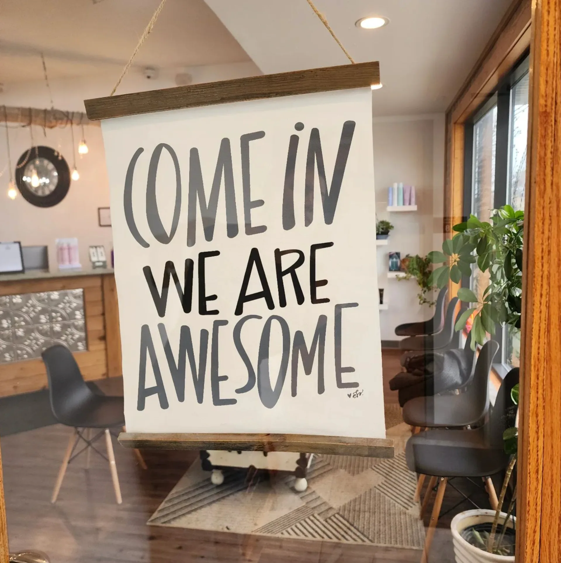 Hand-lettered 'Come In We Are Awesome' sign at the entrance of Dockside Salon in Muskegon